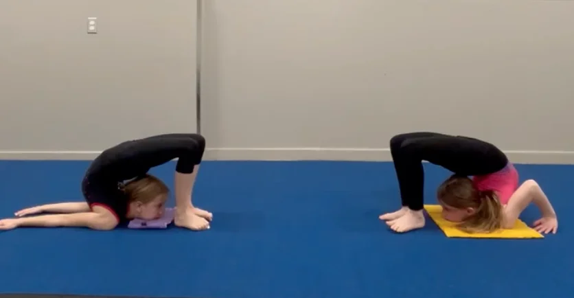 A group of children in an Ottawa contortion class at Capital Circus, practicing a group stretch in a fun, supportive environment.